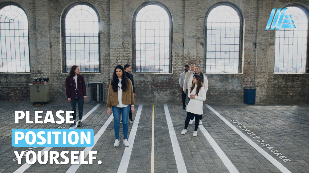 A group of people in the centre of the picture with the slogan “Please position yourself”.