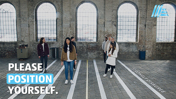 A group of people in the centre of the picture with the slogan “Please position yourself”.