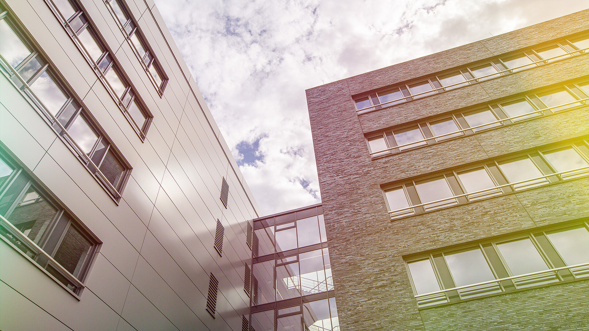 A building with windows against a background showing the sky.