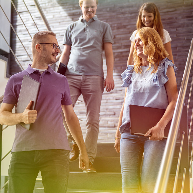A group of people walking down a flight of stairs.