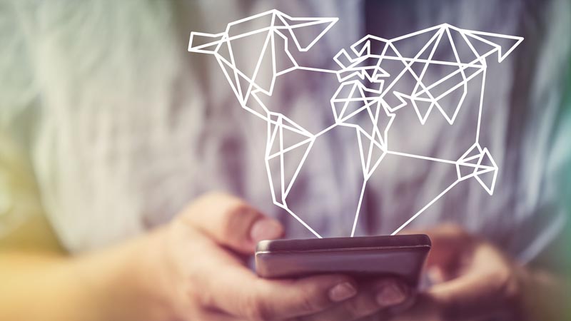 Image shows a hand holding a smartphone with a hologram of diagrams floating above it.